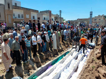 Похороны убитых в Хуле. Фото Reuters